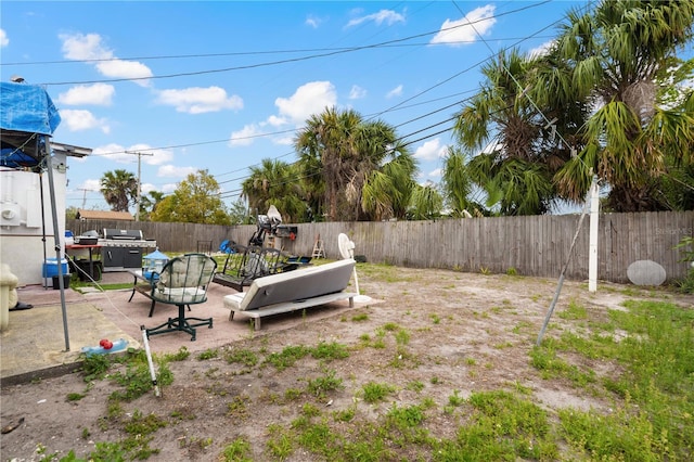 view of yard with a patio area, a fenced backyard, and an outdoor living space