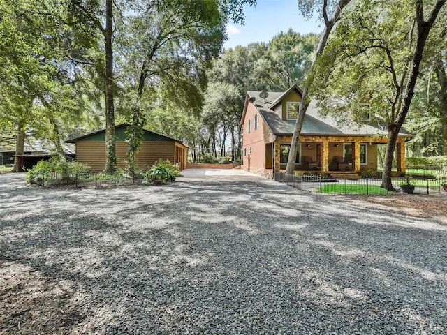 view of front of home with driveway and fence