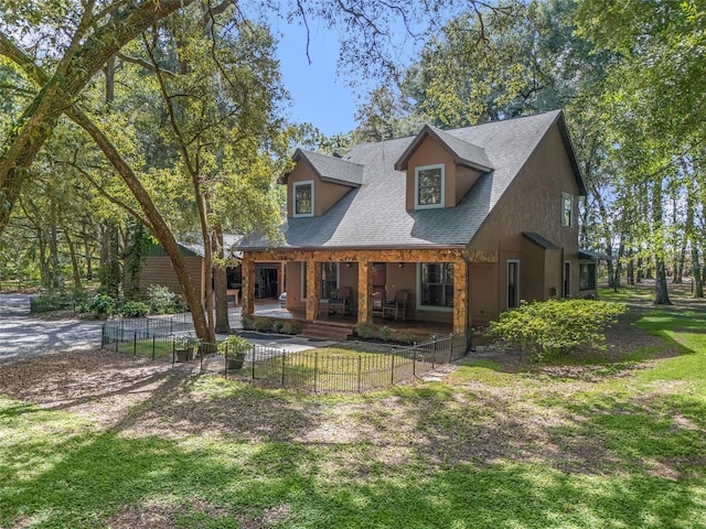 rear view of property with a shingled roof, fence, a lawn, and a patio