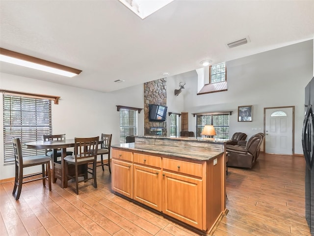 kitchen featuring open floor plan, plenty of natural light, visible vents, and light wood-style floors