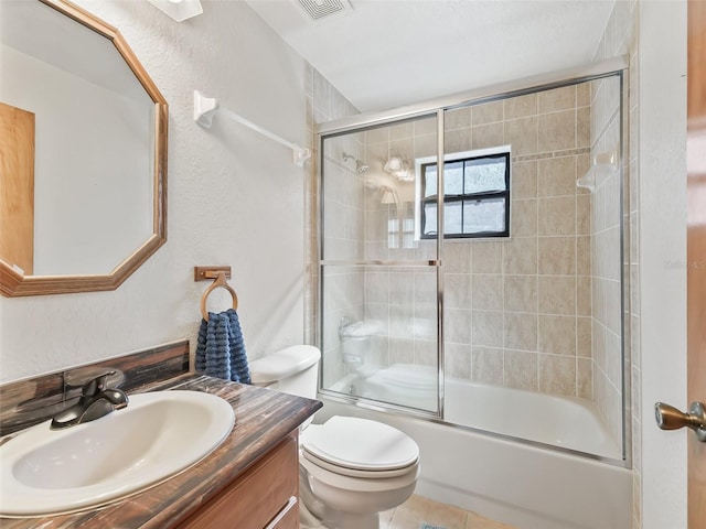 bathroom with tile patterned flooring, toilet, shower / bath combination with glass door, visible vents, and vanity