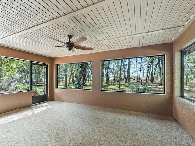 unfurnished sunroom featuring wood ceiling and ceiling fan