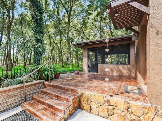 wooden deck featuring a sunroom