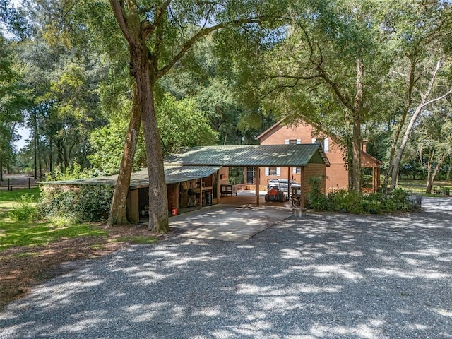 view of front of house with metal roof and driveway