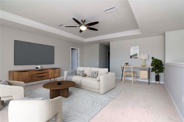 carpeted living area with visible vents, ceiling fan, baseboards, and a tray ceiling