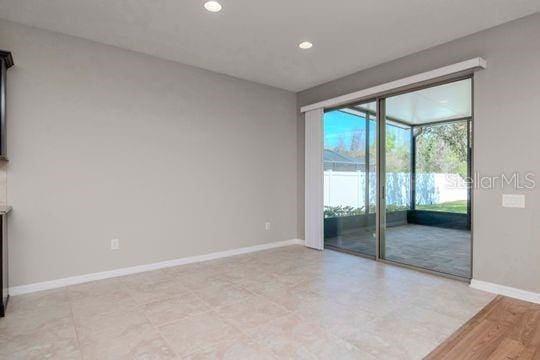 unfurnished room featuring recessed lighting and baseboards