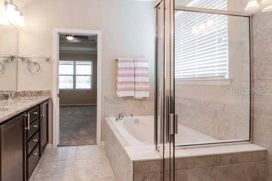 full bathroom featuring tile patterned floors, a garden tub, a shower stall, and vanity