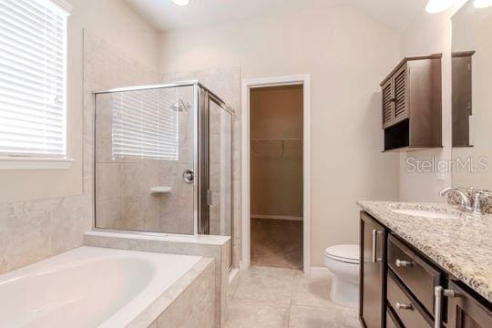 full bath featuring a bath, tile patterned floors, a stall shower, and vanity