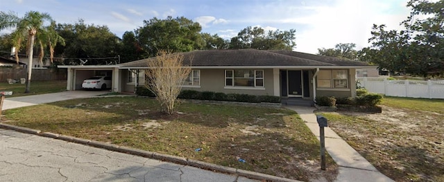 single story home featuring driveway, an attached carport, fence, a front lawn, and stucco siding