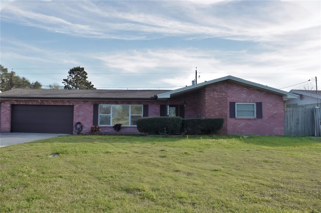 single story home featuring brick siding, an attached garage, driveway, and a front lawn