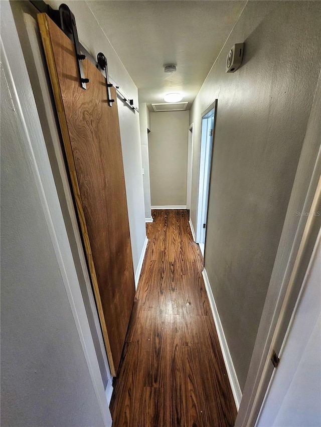hallway with baseboards and wood finished floors
