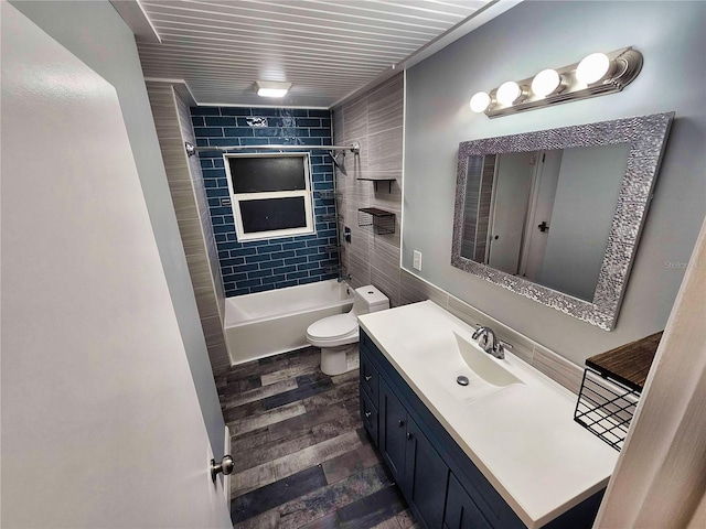 bathroom with tub / shower combination, toilet, vanity, and wood finished floors