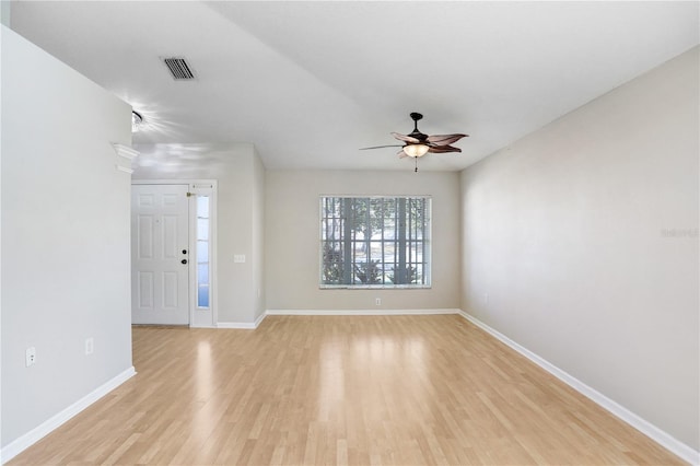 interior space featuring visible vents, light wood-style flooring, a ceiling fan, and baseboards