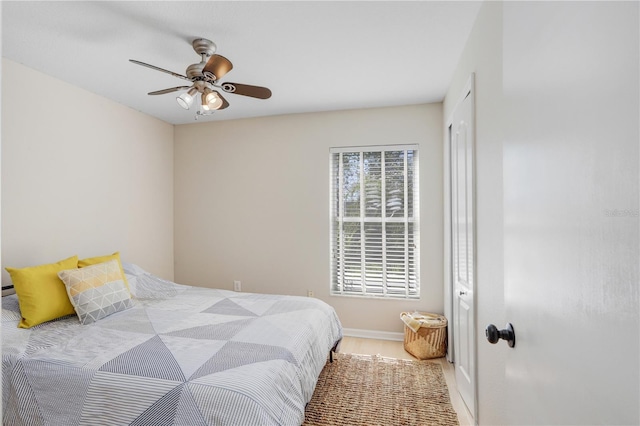 bedroom featuring baseboards and ceiling fan