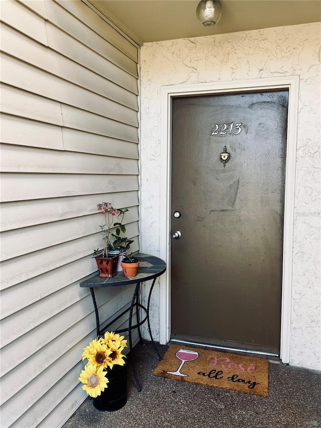 doorway to property with stucco siding