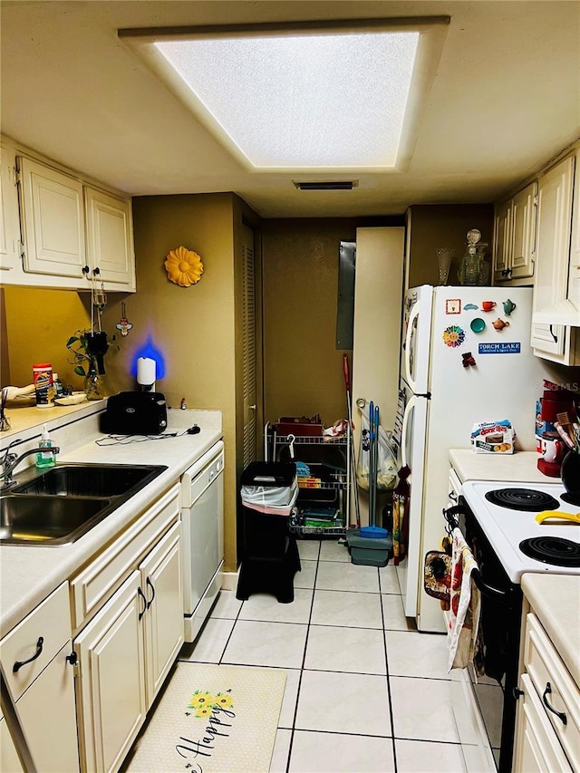 kitchen with electric range oven, light tile patterned flooring, a sink, light countertops, and dishwasher