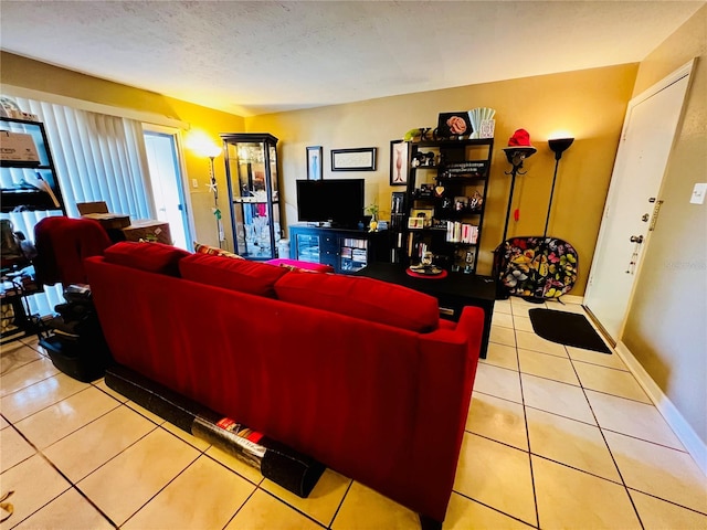 tiled living room featuring a textured ceiling and baseboards