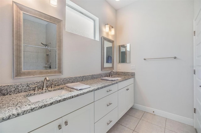 full bathroom with tile patterned flooring, a sink, baseboards, and double vanity