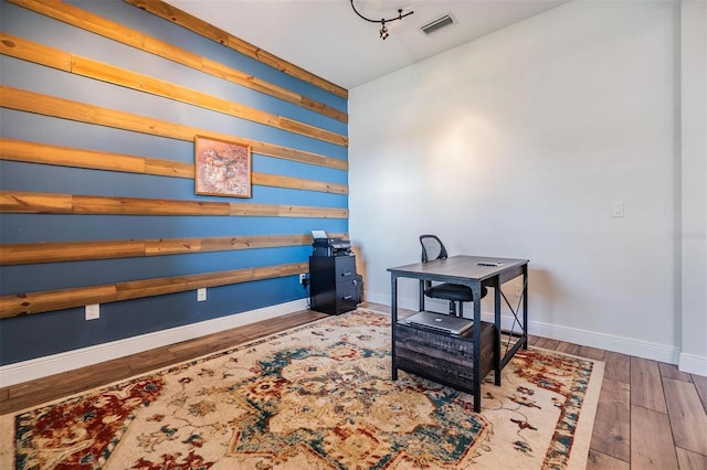 home office with visible vents, baseboards, and wood finished floors
