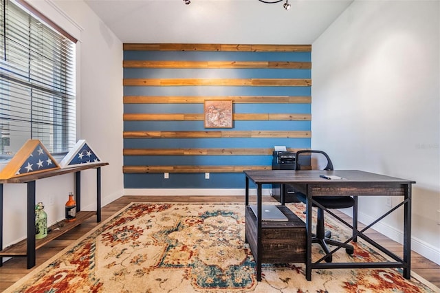 office area featuring baseboards and wood finished floors