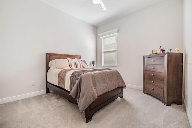 bedroom with light colored carpet, ceiling fan, and baseboards