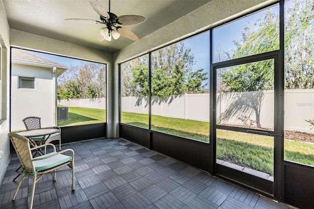 unfurnished sunroom with ceiling fan