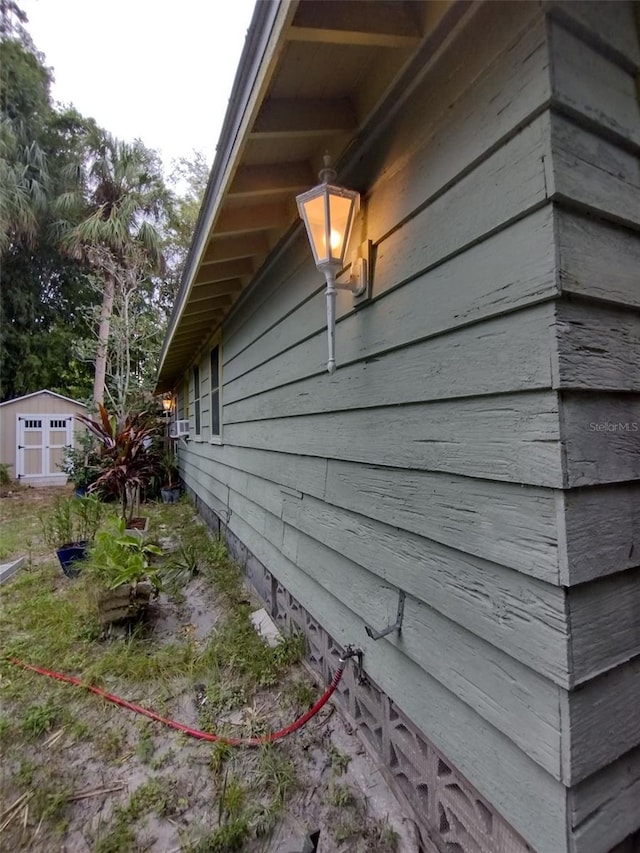 view of property exterior featuring an outbuilding and a shed