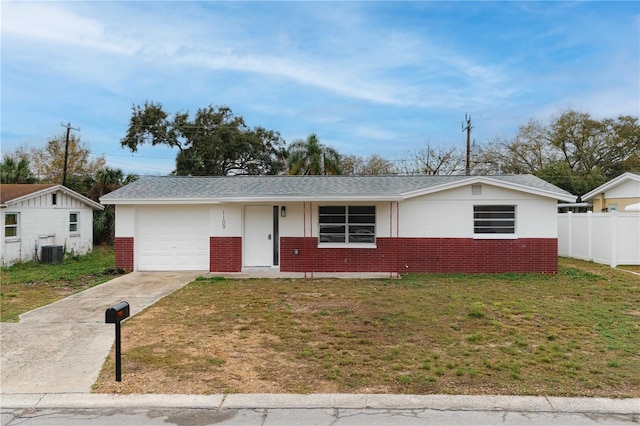 single story home with an attached garage, brick siding, fence, driveway, and a front lawn