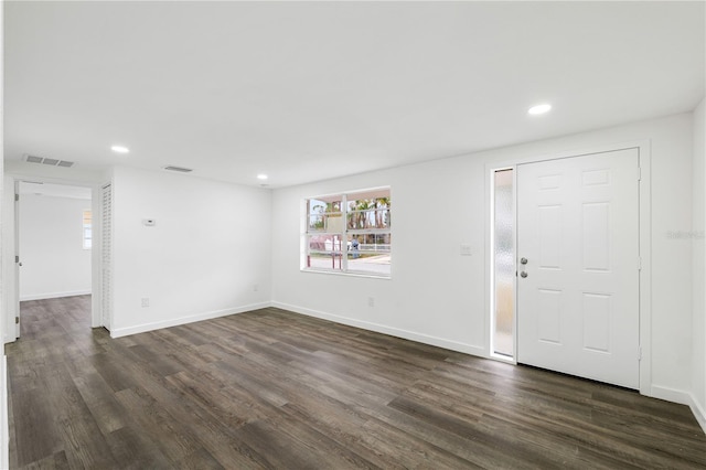 interior space with dark wood-style flooring, recessed lighting, visible vents, and baseboards