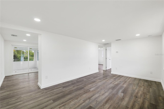 unfurnished room featuring dark wood-style floors, recessed lighting, visible vents, and baseboards