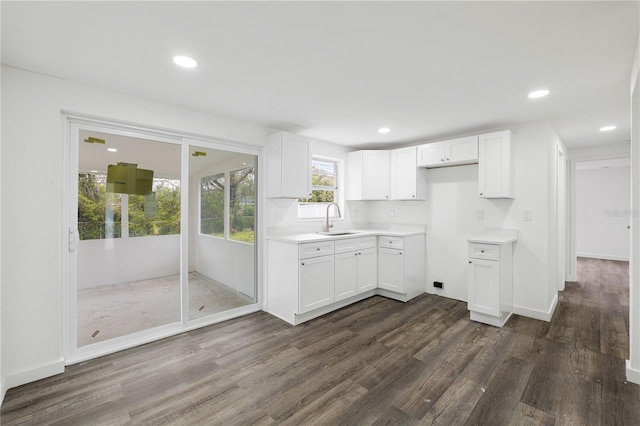 kitchen featuring white cabinetry, dark wood-style flooring, a sink, and recessed lighting