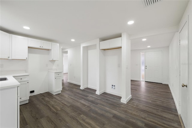 kitchen featuring white cabinets, dark wood-style flooring, and recessed lighting