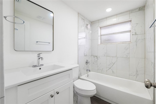 bathroom featuring bathtub / shower combination, vanity, and toilet