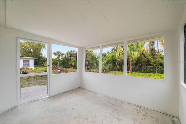 unfurnished sunroom featuring lofted ceiling