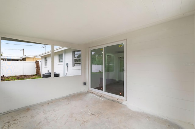 view of patio with central AC unit and fence