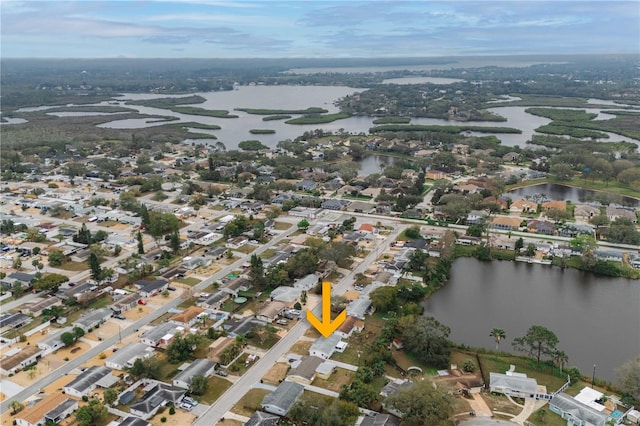 drone / aerial view featuring a water view and a residential view