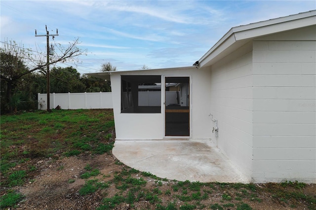 entrance to property with a patio and fence