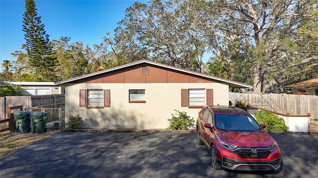 view of property exterior with fence and stucco siding