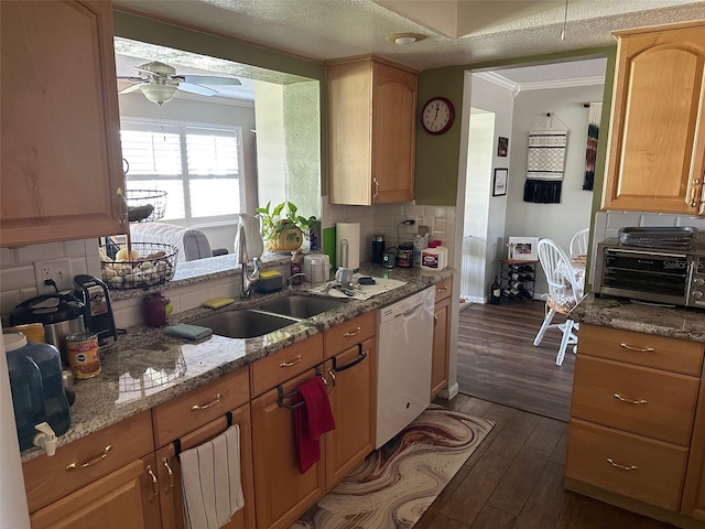 kitchen featuring white dishwasher, a sink, a ceiling fan, dark wood-style floors, and crown molding