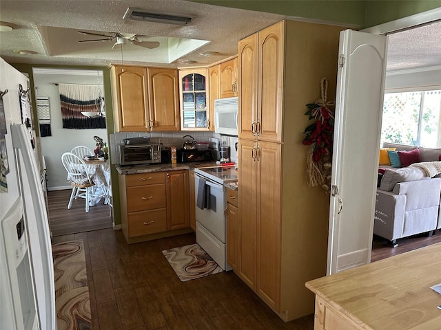 kitchen with white appliances, visible vents, dark wood-style floors, and a textured ceiling