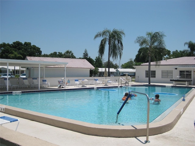 pool featuring a patio area and fence