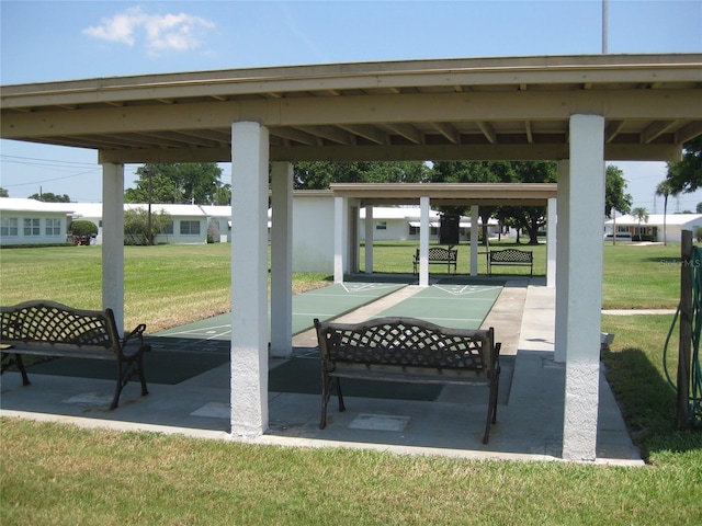 surrounding community featuring a lawn and shuffleboard