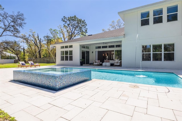 view of pool featuring fence, outdoor lounge area, a fenced in pool, an in ground hot tub, and a patio area