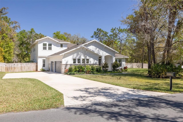 view of front facade with a front yard, driveway, and fence