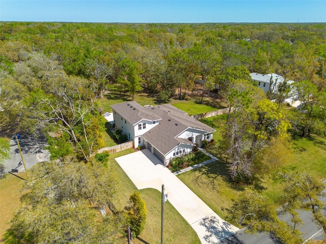 birds eye view of property featuring a view of trees