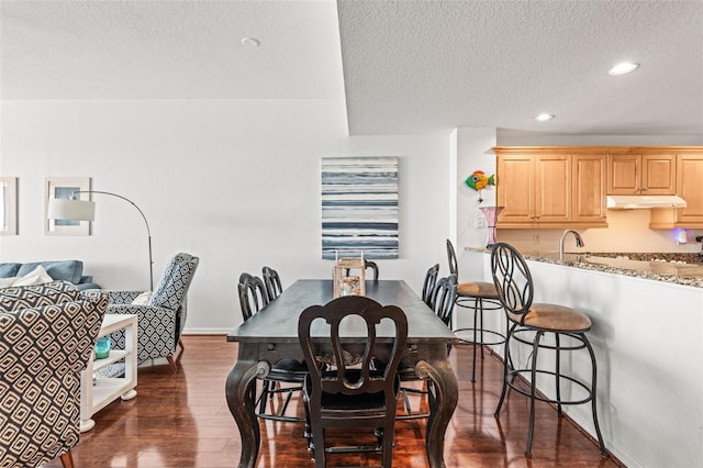 3805 Gulf Blvd Unit 404, St Pete Beach, FL 33706 - dining area featuring a textured ceiling, dark wood finished floors, recessed lighting, and baseboards