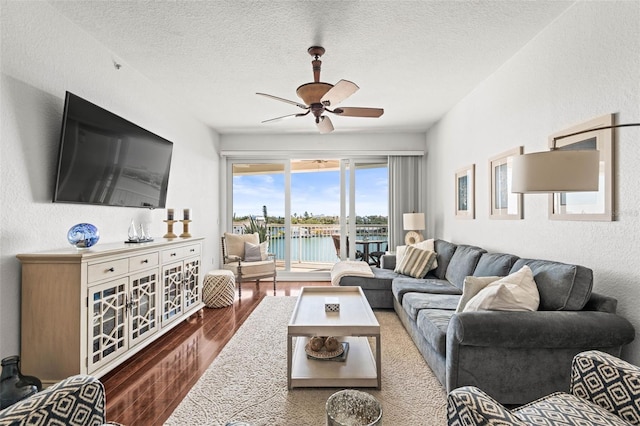 3805 Gulf Blvd Unit 404, St Pete Beach, FL 33706 - living room with wood finished floors, a ceiling fan, and a textured ceiling