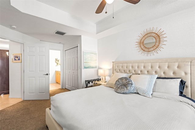 3805 Gulf Blvd Unit 404, St Pete Beach, FL 33706 - bedroom with a closet, light tile patterned floors, connected bathroom, light colored carpet, and ceiling fan