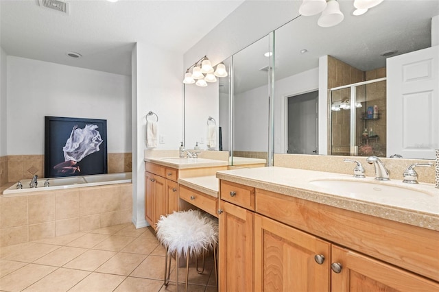 3805 Gulf Blvd Unit 404, St Pete Beach, FL 33706 - bathroom with vanity, tile patterned floors, a shower stall, and a garden tub