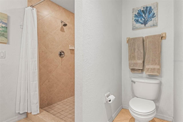 3805 Gulf Blvd Unit 404, St Pete Beach, FL 33706 - bathroom featuring a tile shower, tile patterned flooring, and a textured wall
